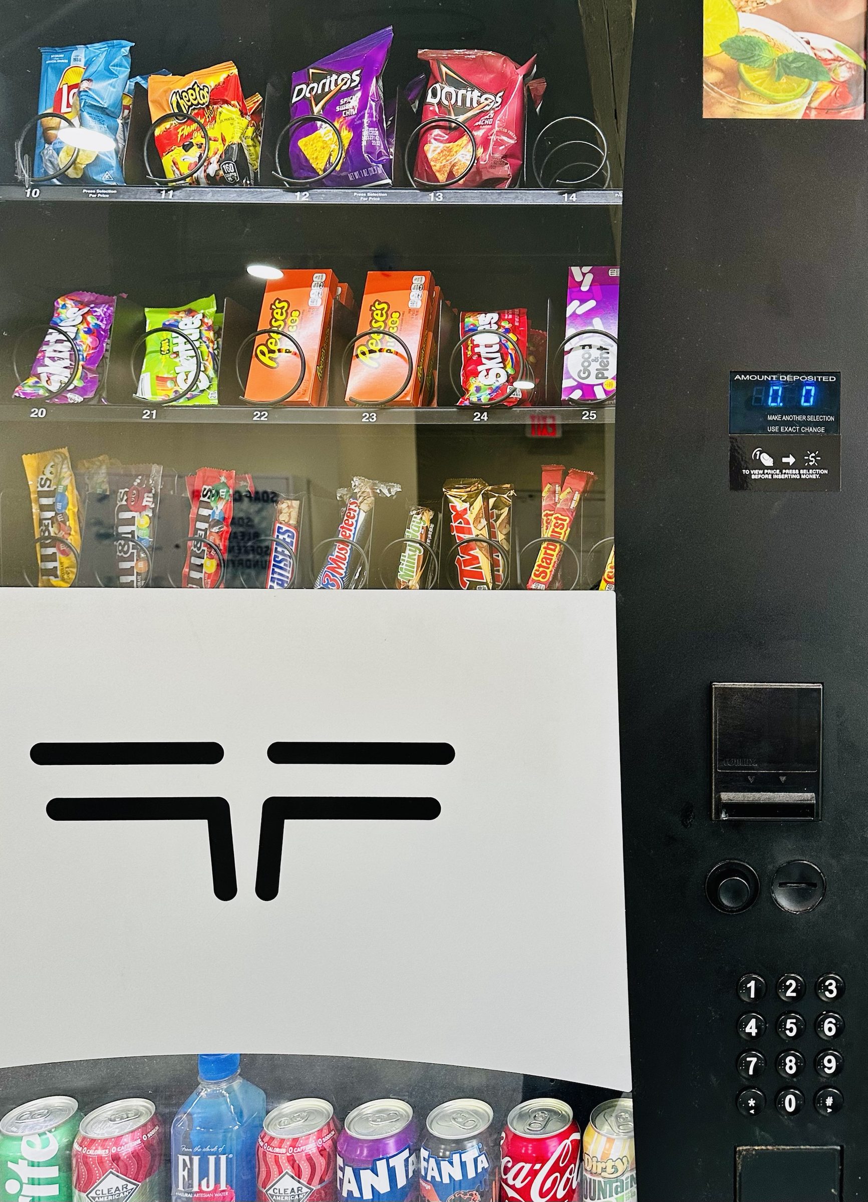 Vending machine stocked with snacks and drinks